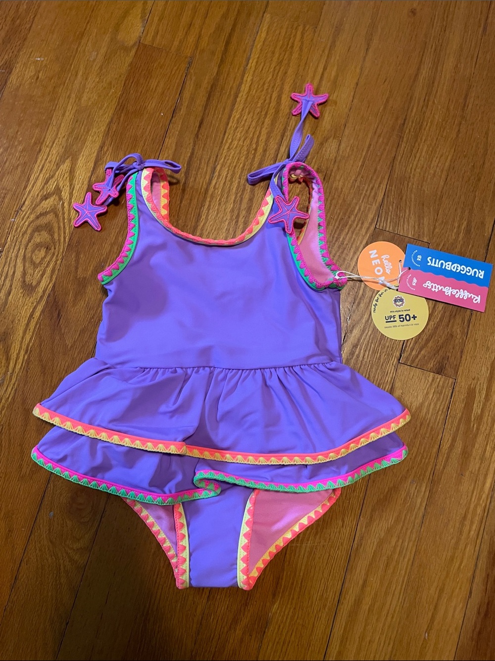 NWT Ruffle Butts 2T Purple One-Piece Swimsuit Neon Trim Star Ties Crochet Peplum